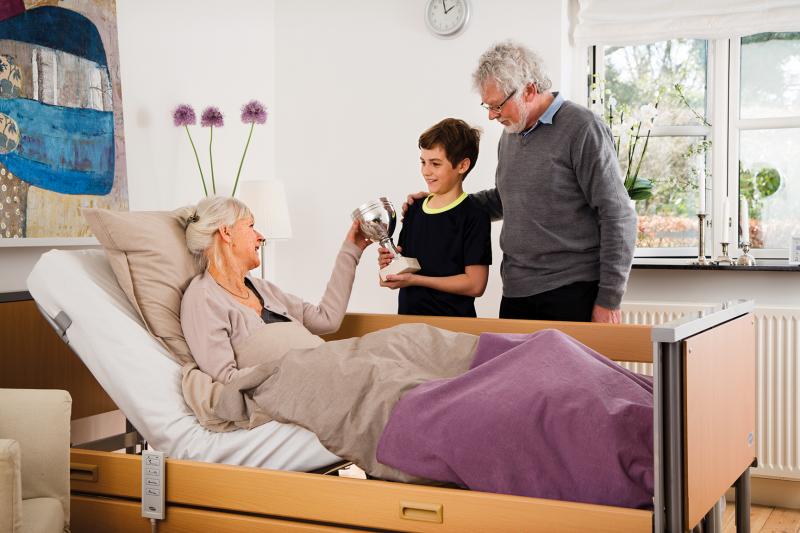patient in Invacare Accent Hospital bed with rails patient in Invacare Accent Hospital bed with rails